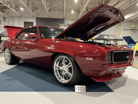 Front three-quarter view of the red Camaro with the hood open